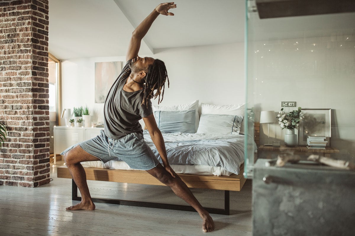 man-doing-yoga-in-his-room-1200x800